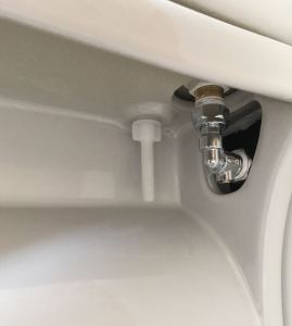 Toilet Cistern with Penny valve for turning water off and on at the toilet.
